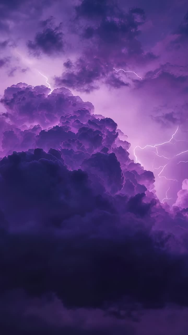 Vertical video: Brightening cumulonimbus cloud filling sky, showing inner purple glow and lightning