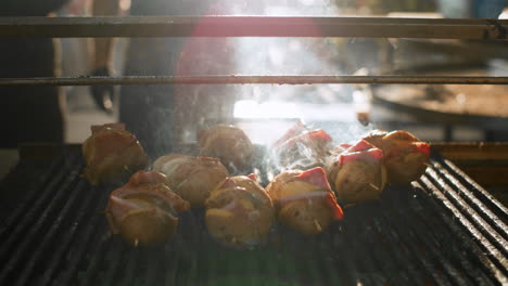 Grilled-potato-with-ham-preparing-outdoors.-Chef-man-cooking-on-backyard.