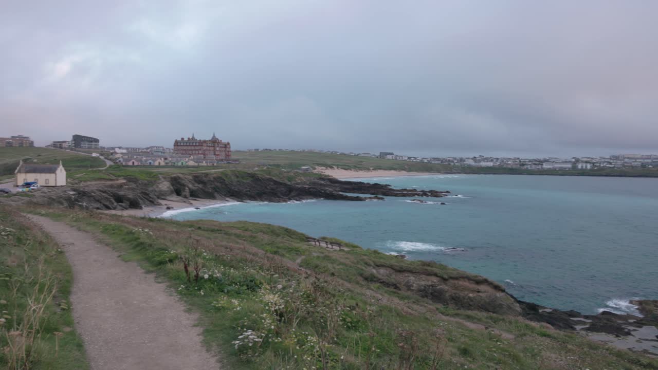 Panning shot revealing Fistral beach and the Headlands Hotel in Newquay