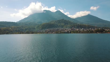 Drone-aerial-flying-over-the-beautiful-blue-lake-atitlan-in-Guatemala---Mountains-and-volcanoes-landscape