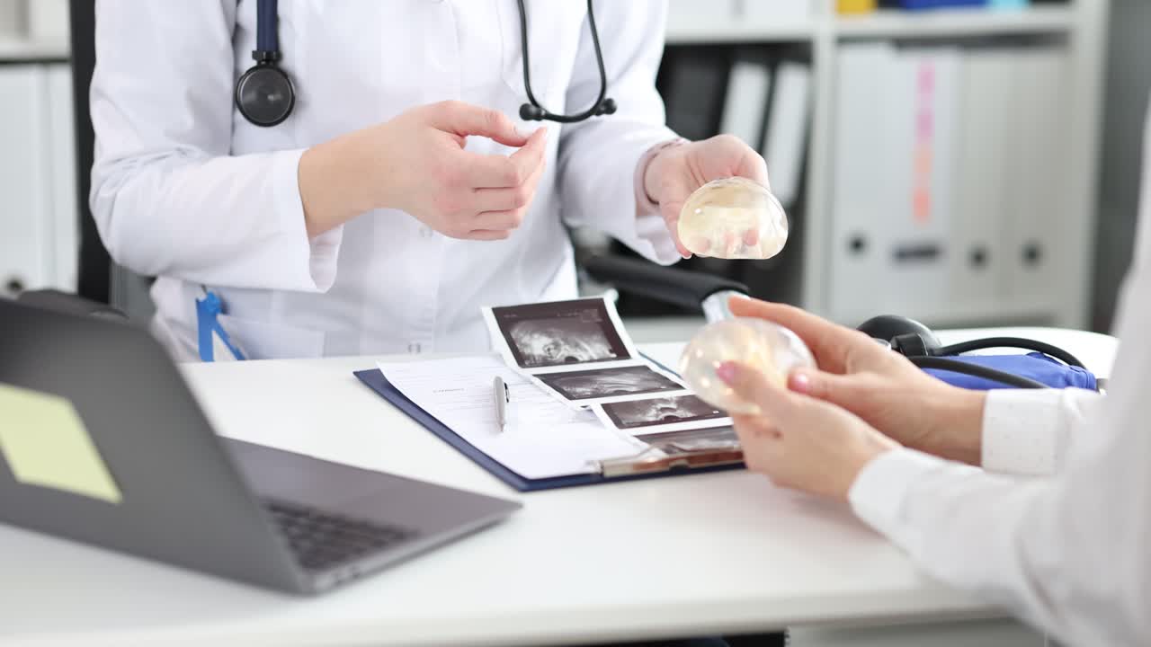Doctor Explains Breast Implants to Patient