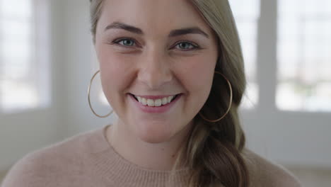 portrait of attractive young blonde woman smiling friendly looking at camera close up