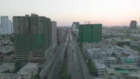 aerial shot of highway running through chorangi in karachi with residential apartments under construction