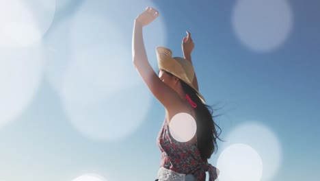 animation of dots over happy caucasian woman on beach