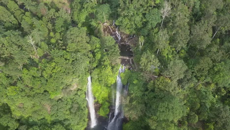 aerial tilt from top of bali jungle waterfall with several cascades