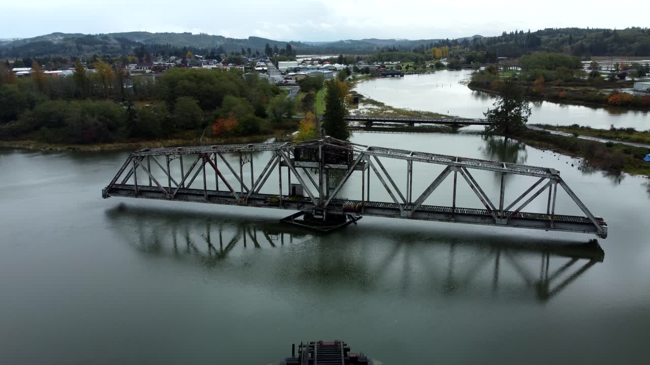 US, WA, Raymond, 2025-10-25 - Drone view of the abandoned train trestle rotating bridge on the Willapa River