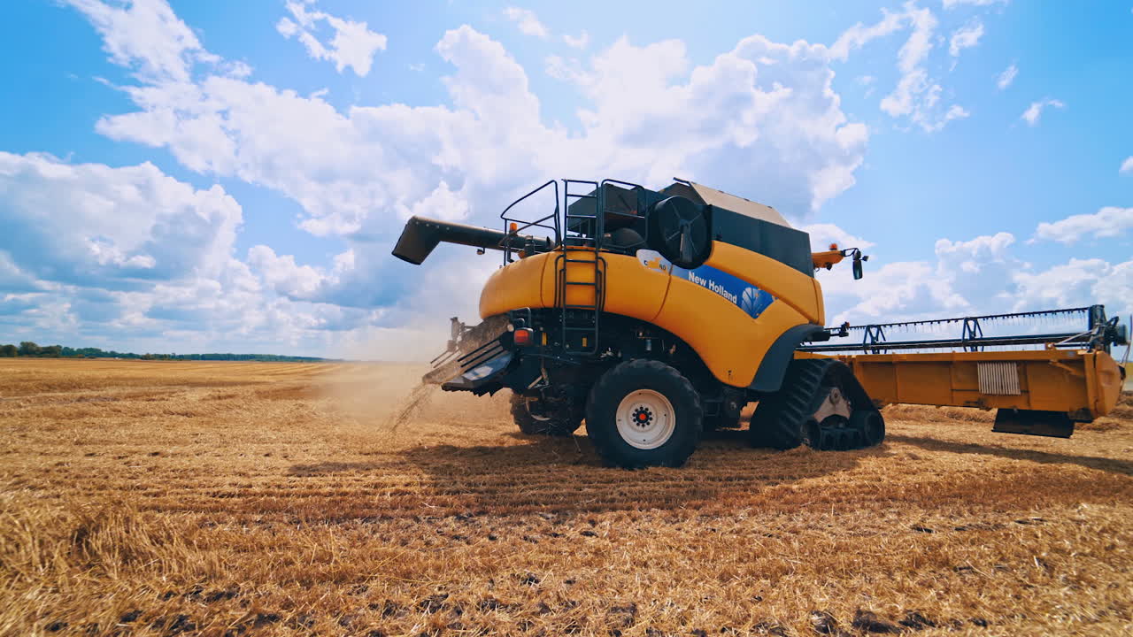 Harvesting machine working in field. Combine harvester working on the large wheat field