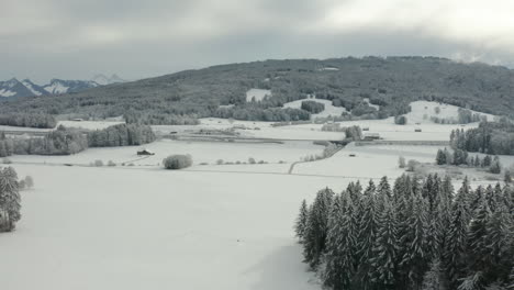 Aerial-of-beautiful-snow-covered-landscape-in-Vaud,-Switzerland