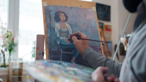 artist painting a portrait of a woman in an art studio