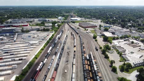 train and storage facility in an establishing drone shot showing deep forest in the distance