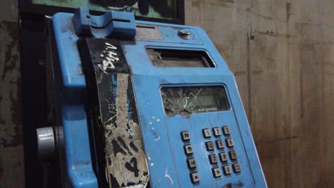 vintage telephone, broken machine closeup, public phone, vandalized at city streets