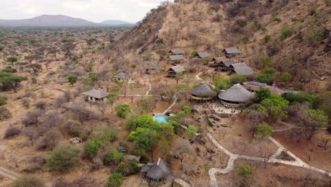 a nice aerial drone shot of sangaiwe tented lodge with a swimming pool overlooking the impressive tarangire national park in tanzania in africa