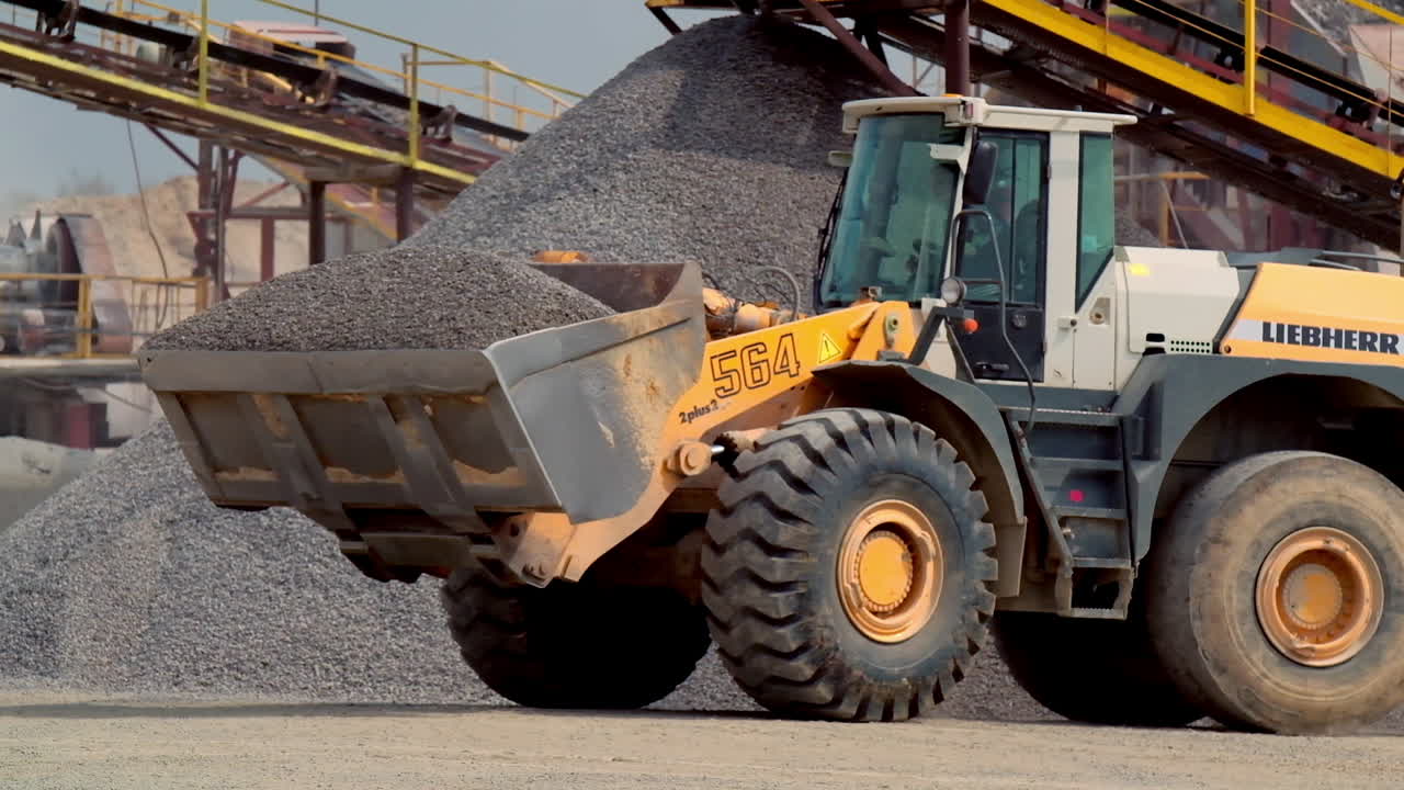 Excavator at mining quarry. View of bulldozer moving at quarry