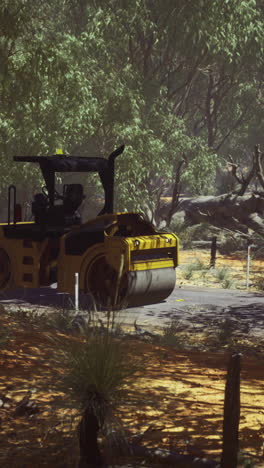 construction machine prepares land in a serene forest during afternoon sunlight