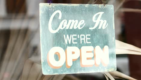 open sign hanging front of cafe