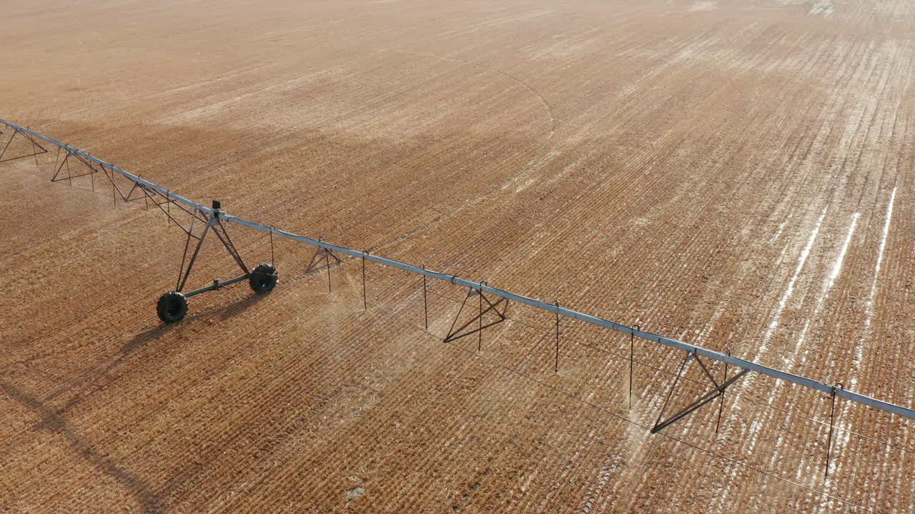 Drought requires irrigation system to water field of crops in spring growing season