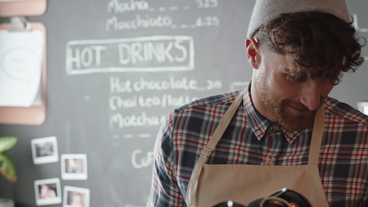 hombre barista feliz sirviendo a los clientes comprando café en un café ocupado disfrutando de un servicio amigable
