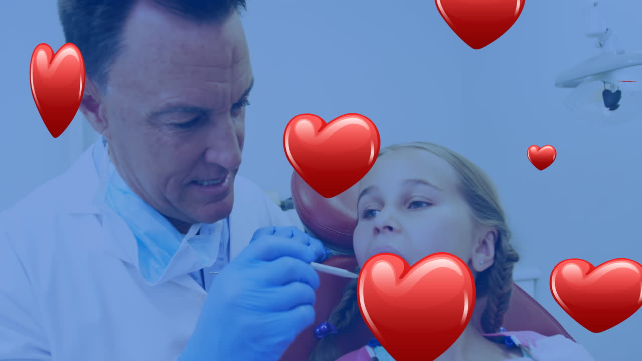 Animação de ícones de coração sobre um dentista caucasiano atendendo uma garota caucasiana