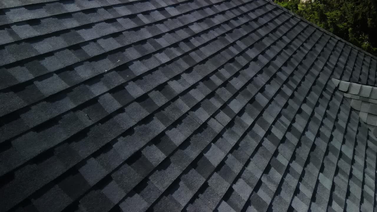Detailed close-up of shingles on a freshly installed roof, showcasing texture and quality craftsmanship. Ideal for roofing and home improvement content.