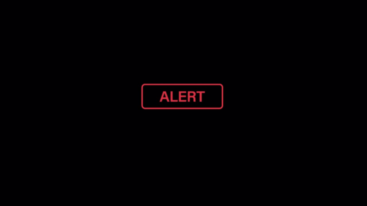 Red Alert Text Notification Appearing on Black Background