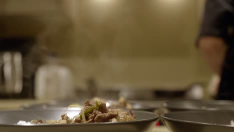 person preparing freshly cook korean meal on plates