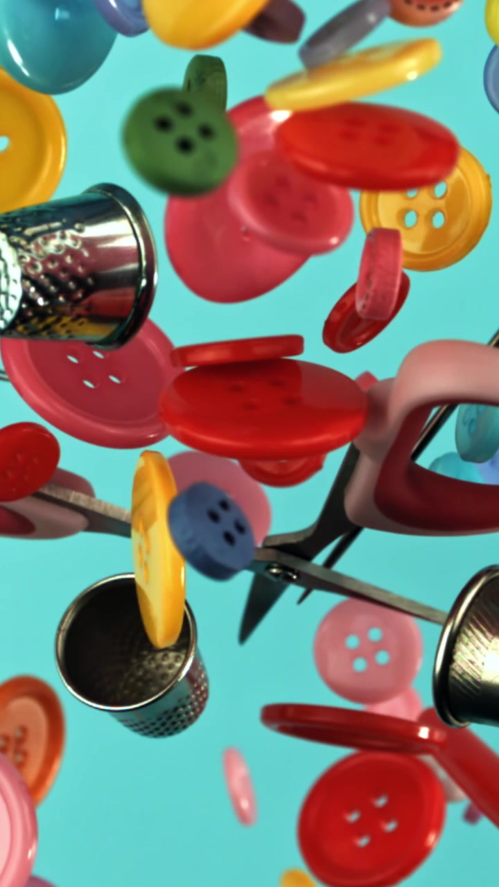 Colorful Sewing Buttons and Craft Tools Floating on Blue