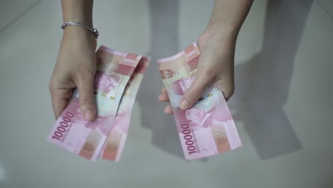 female hands counting money rupiah