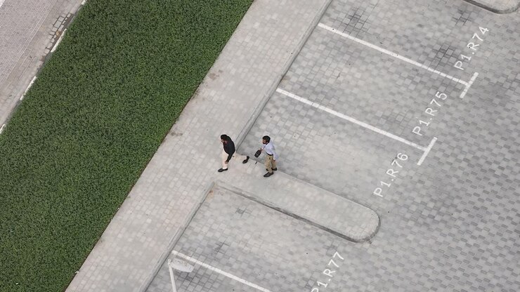 Two men walking in a parking lot