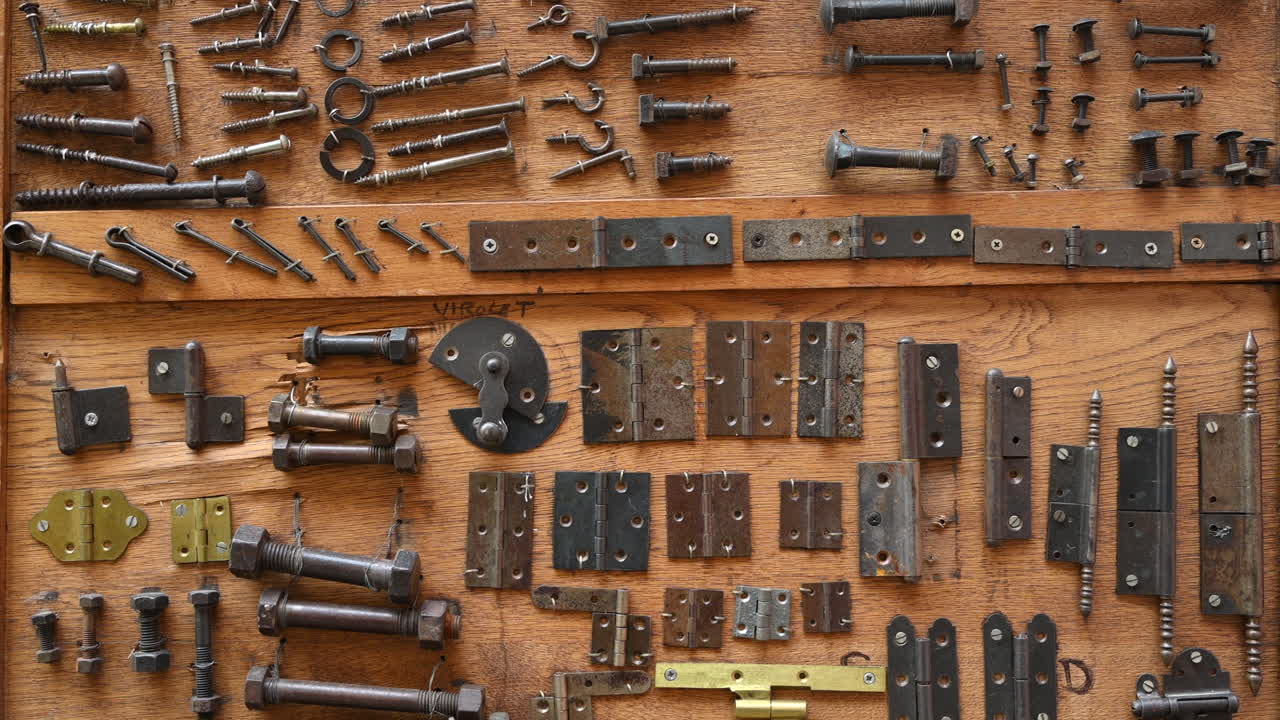 Different types of screws and other instruments in a wooden tool box