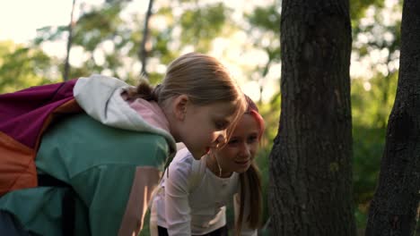 two girls exploring in a forest