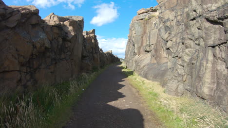 4k moving shot on a stone footpath between two large rocks in varberg, sweden