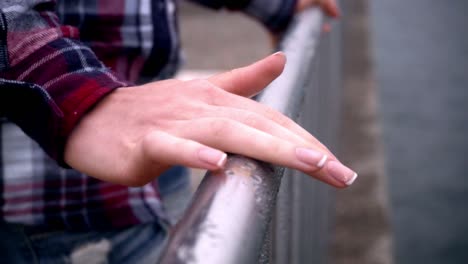 woman hands on steel fence. elegant woman manicured hands