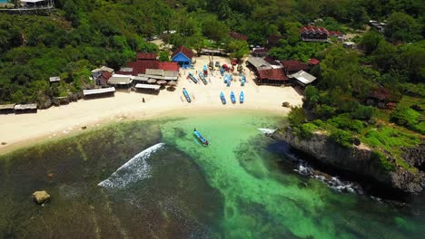 aerial shot of tropical beach with traditional fisherman ship on the village with ship sailing