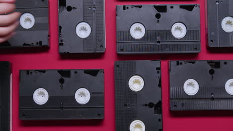 vhs cassettes on burgundy background