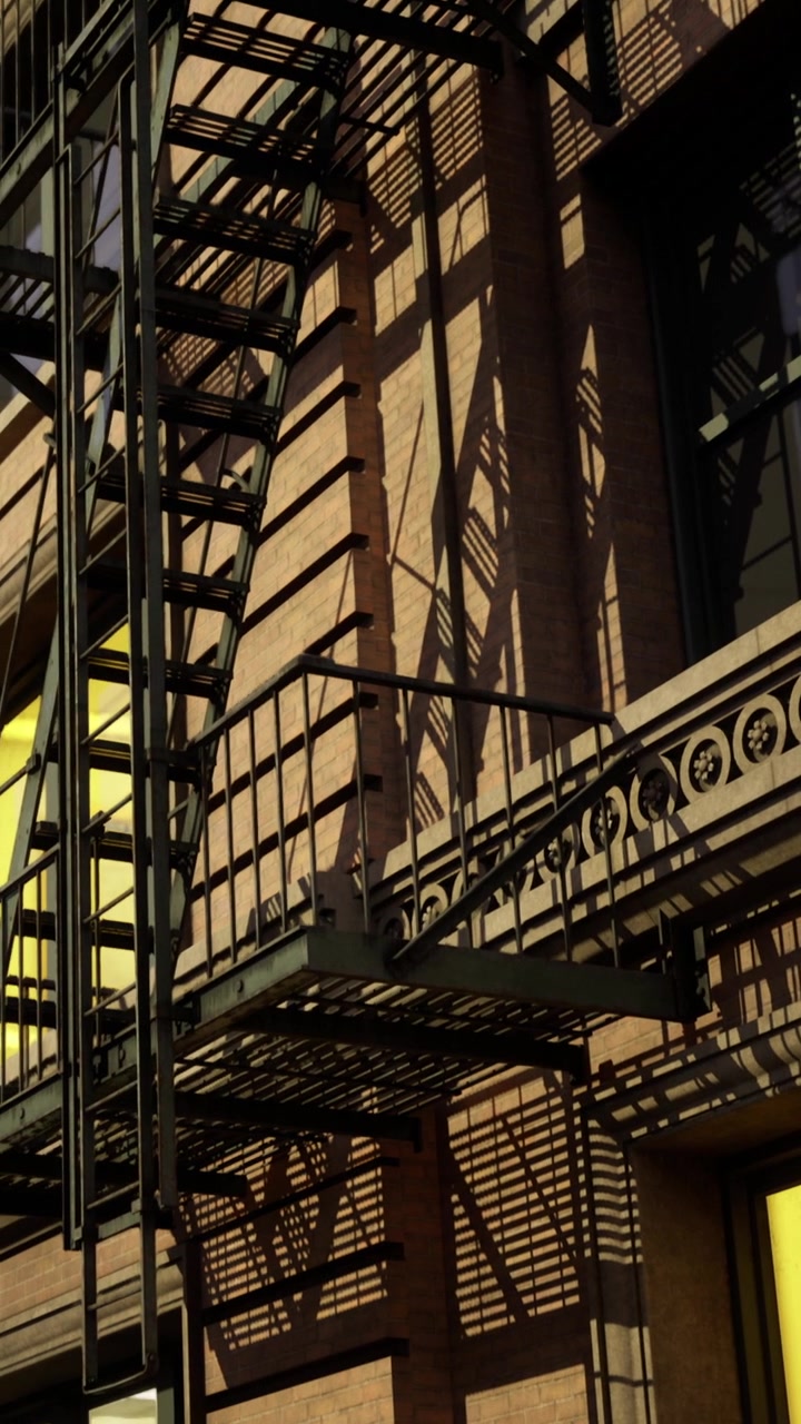 Shadows cast by a fire escape on a brick building in the early evening
