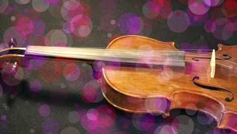 swirly bokeh colourfully surrounds a violin