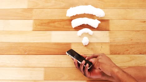hands using mobile phone with wifi sign