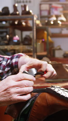 shoemaker repairing a shoe