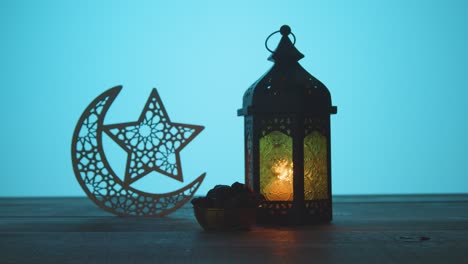 tracking shot of a lantern dates on table during dusk ramadan celebrations