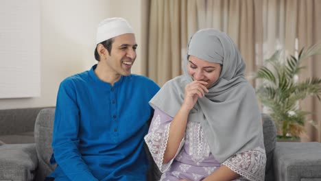 happy muslim couple laughing and talking