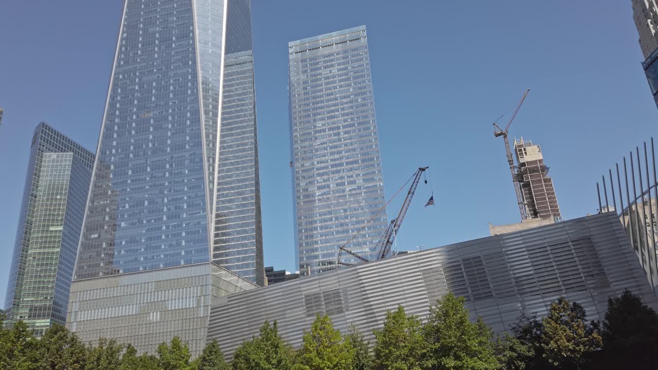 Tower cranes in front of a construction of two glass skyscrapers in New York