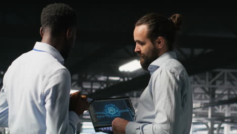data center team leader and worker reviewing performance dashboards of ai