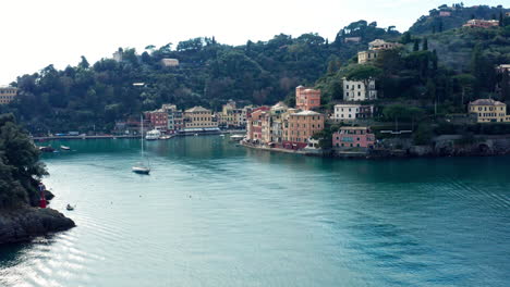 Pastel-colored-houses-on-Portofino-Lugurian-coastline,-aerial-approach