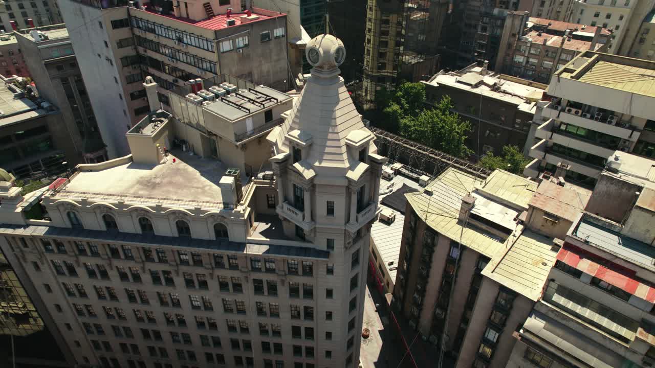 Aerial orbit of the Arizt&iacute;a Building - first skyscraper in Santiago Chile on a sunny day - La Bolsa Neighborhood