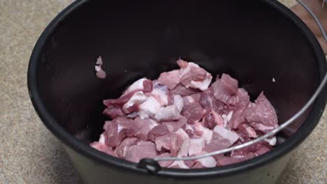 piezas de cerdo frescas en un balde para barbacoa, proceso de separación de carne