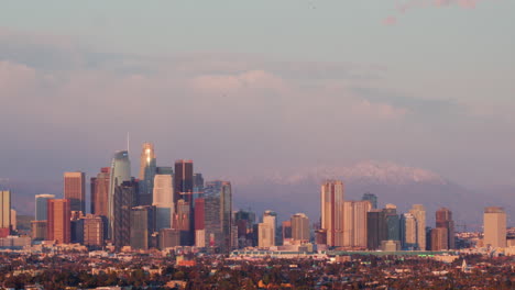 LA-skyline-with-the-Santa-Monica-mountains-with-snow-on-them-at-sunset