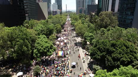 drone-shot-of-the-pride-parade-2023-in-mexico-city-in-front-of-the-corporate-buildings-of-paseo-de-la-reforma