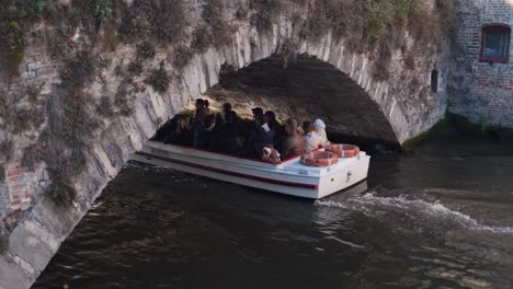 Boat trip under a historic stone bridge in Bruges