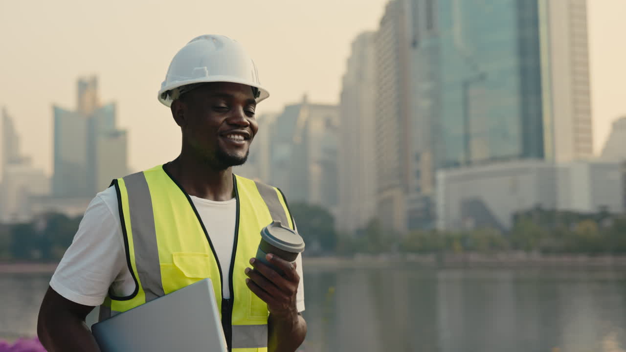 Construction Worker with Laptop and Coffee