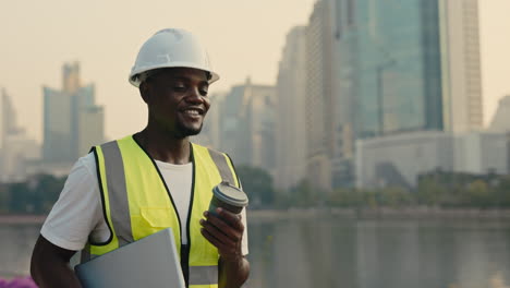 construction worker with laptop and coffee